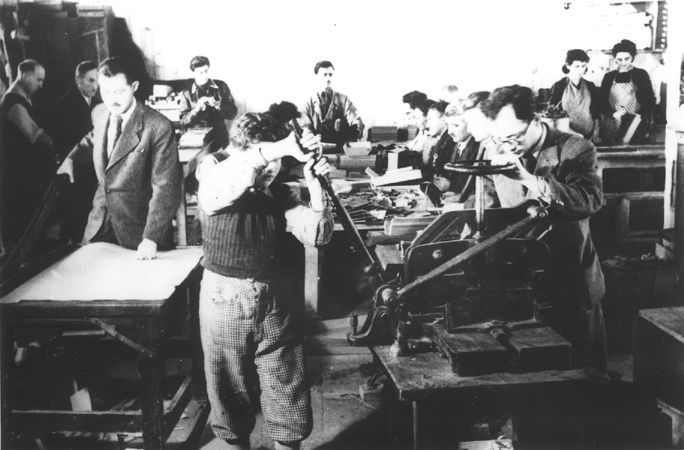 Prisoners making paper products in a factory at the Novaky labor camp